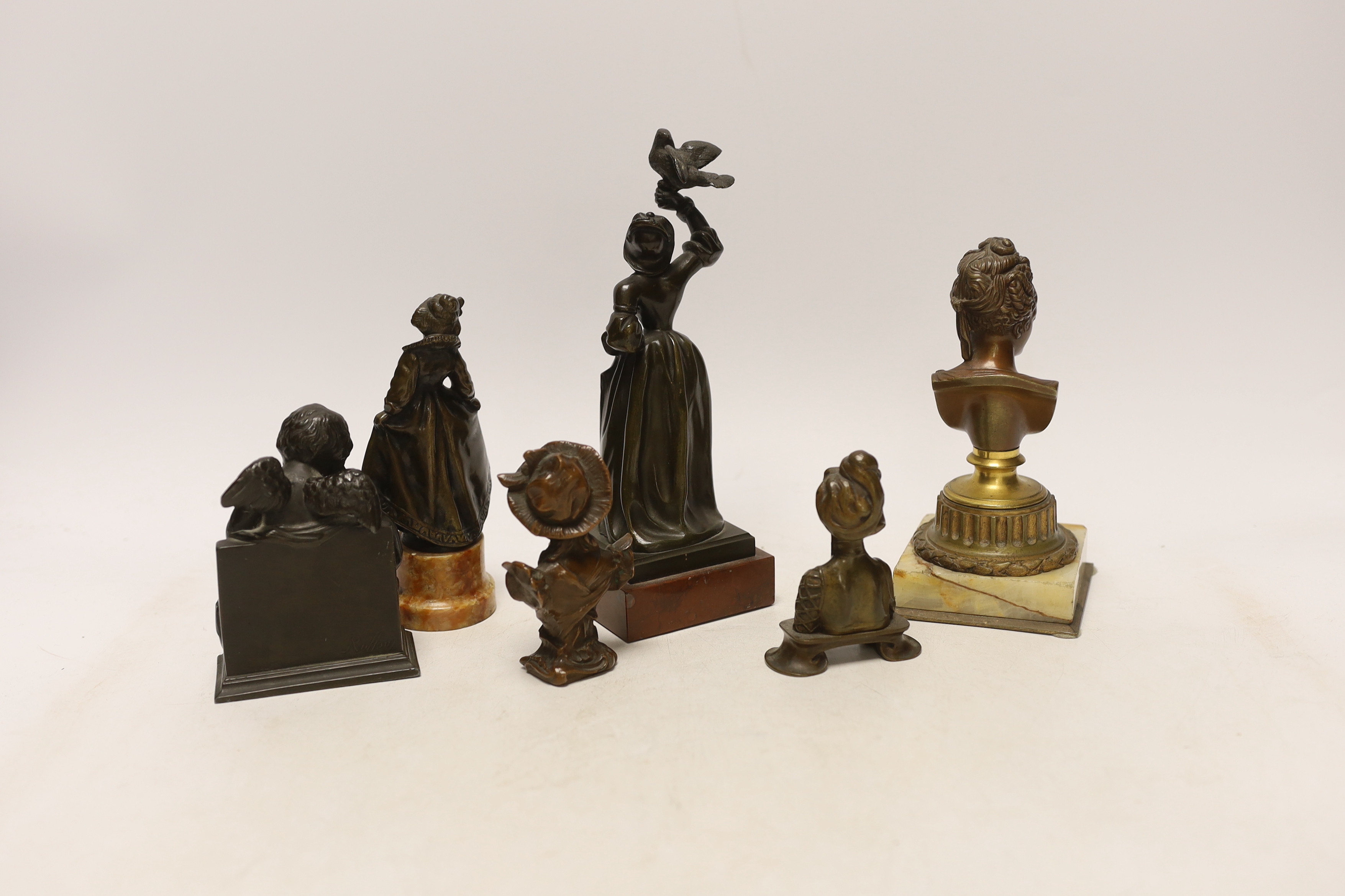 Two bronze figures, one bone mounted, three bronze busts and a patinated spelter figure of Cupid, 19th/early 20th century, 20cm high